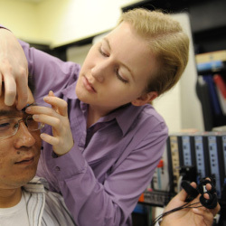 Researcher attaches physiological sensors to study participant