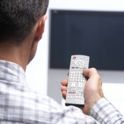 man with TV remote control