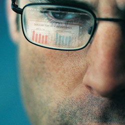 info table reflected in man's glasses