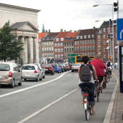 bikes and cars during rush hour