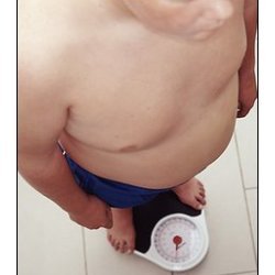 man getting weighed on scale
