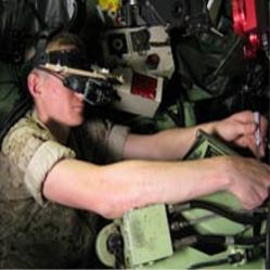 U.S. Marine technician wears an augmented-reality headset as he carries out a maintenance task inside an armored vehicle. 