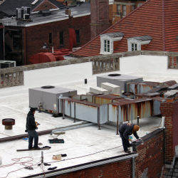 workers on a white roof