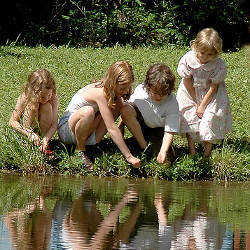 children by a pond