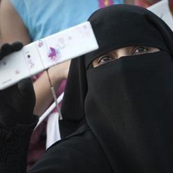 Woman in burka with cell phone