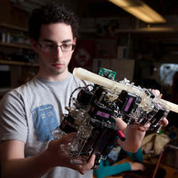 Cornell undergraduate Jeremy Blum holding prototype robot