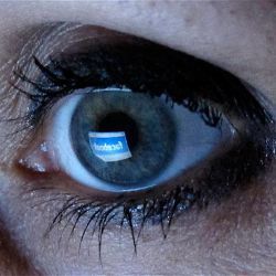 eye reflecting Facebook screen 