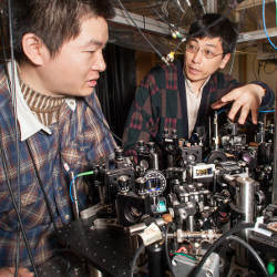 Xibo Zhang and Cheng Chin with experimental hardware