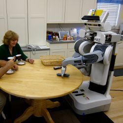 robot and senior in kitchen