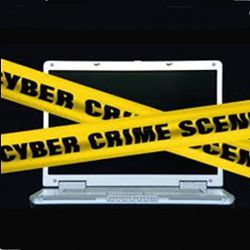 laptop with 'Cyber Crime Scene' tape