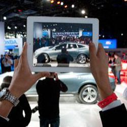 computer tablet taking photo at automotive show