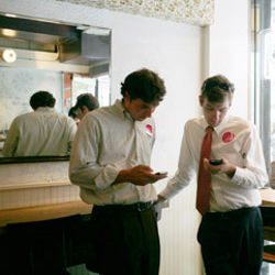 businessmen looking at smartphones