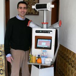 A student and the elderly care robot he developed.