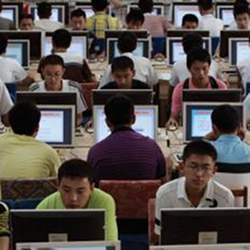 A group of Asians working at computers.