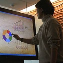 A researcher using a digital whiteboard.