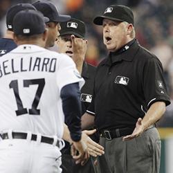 A baseball manager arguing a call with umpires.