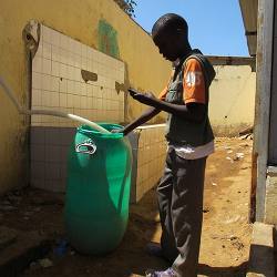 A boy in Senegal with a smartphone reports on sanitary conditions at his school..