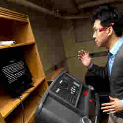 A man on a treadmill reading a screen.