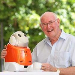 A senior with a robotic companion.