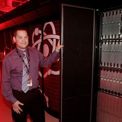 A data center manager shows off the insides of the Big Red II supercomputer.