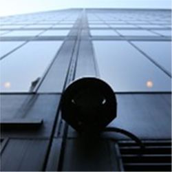 Surveillance camera attached to a building