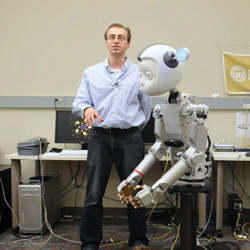 A human researcher working with a humanoid robot.