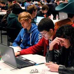 High school students working on programming problems. 