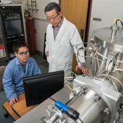 Researchers working with technology used in spintronics research.