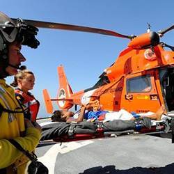 A disaster victim being evacuated by helicopter.