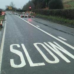 'Slow' painted on a road