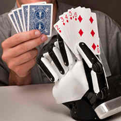 A human and a robot hold playing cards in their hands.