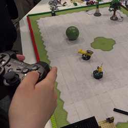 Playing a board game with a video game controller.