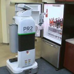 A robot reaches into a refrigerator and grabs a beer.