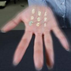 An image of a simple numeric keyboard projected on a hand. 