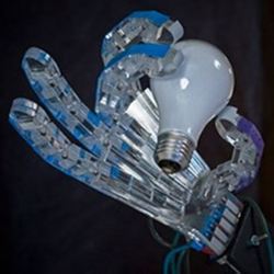 A robotic hand with sufficient sensitivity to pick up a light bulb. 