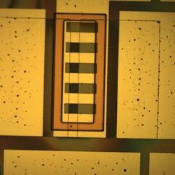 View of a coated silicon circuit that can be implanted into the body.
