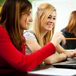 A young women being mentored by another young woman.