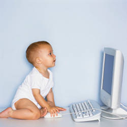 A baby using a computer.