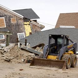 A bulldozer prepares to shovel debris in a disaster area.