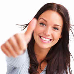 A smiling woman giving the thumbs up gesture. 