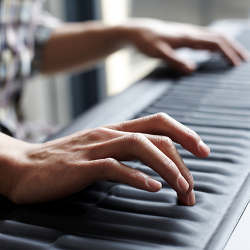 Hands on a musical keyboard.