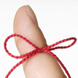 A finger with a string tied around it, signifying a reminder.