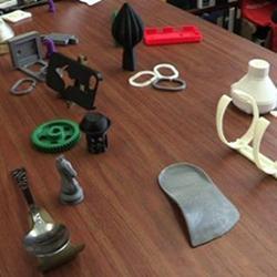 An array of household articles generated by a 3D printer for pennies.