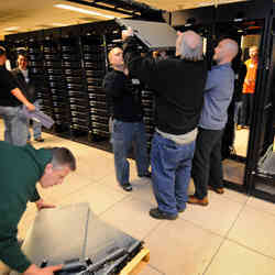 IT workers at Purdue University adding capacity to the Coates compute cluster.