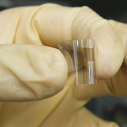 A researcher holding the new micro-supercapacitor.