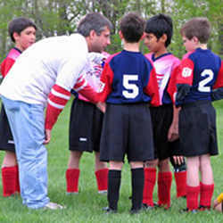 A soccer coach instructing his team.