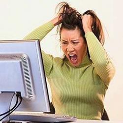 A young woman frustrated with her computer, which does not understand her.