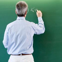 male teacher at blackboard