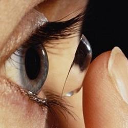 A contact lens wearer inserting a lens. 