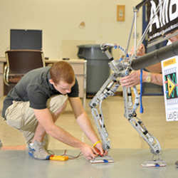 Researchers working on bipedal robotics. 